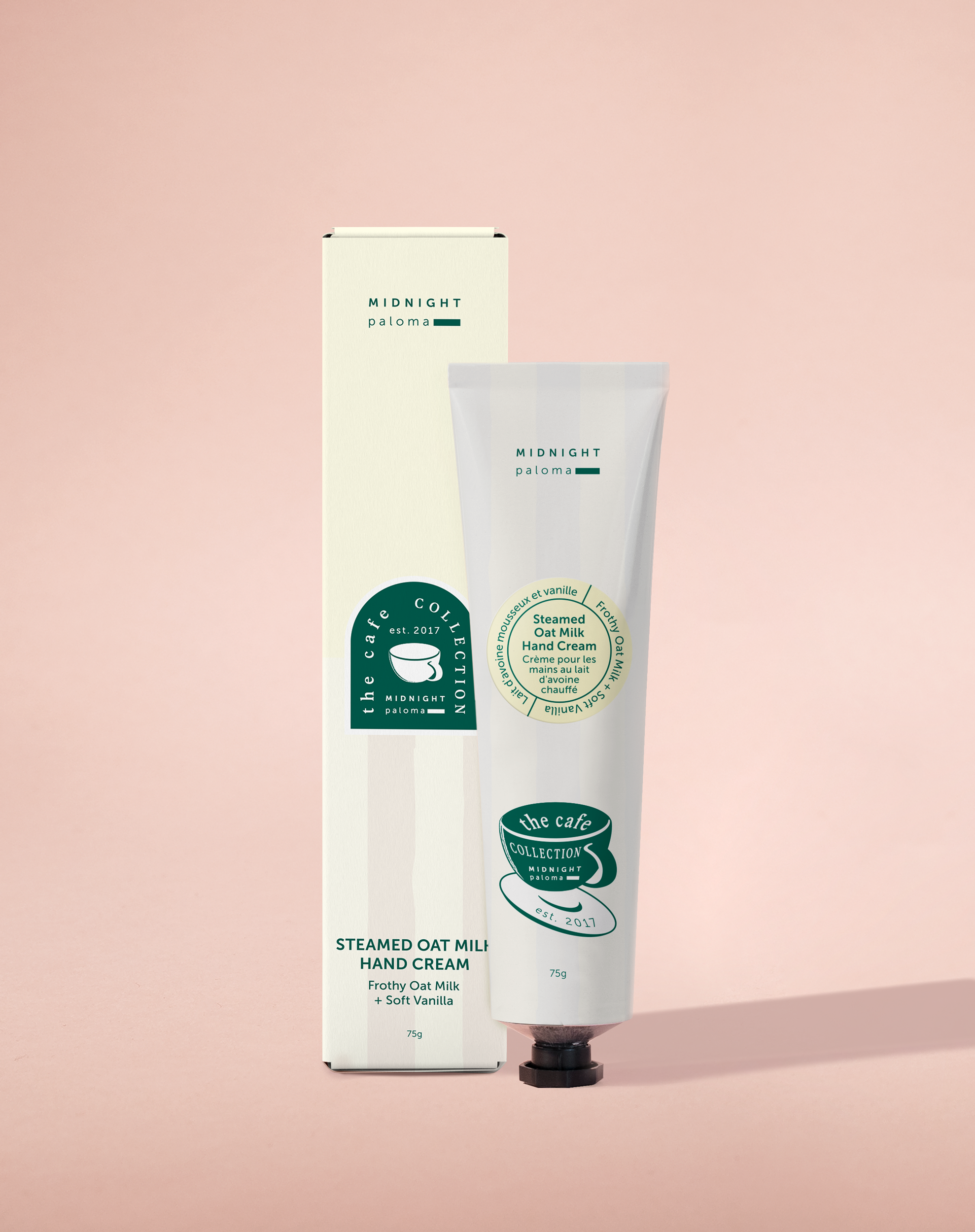 A tube of hand cream with a label that includes a green leafy design and text, placed against a pink background.